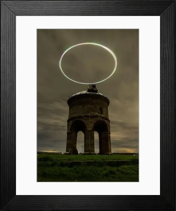 Framed Print : Enigmatic night view of an ancient windmill with a drone light trail creating a halo effect in the dark sky Framed Print : Enigmatic night view of an ancient windmill with a drone light trail creating a halo effect in the dark sky