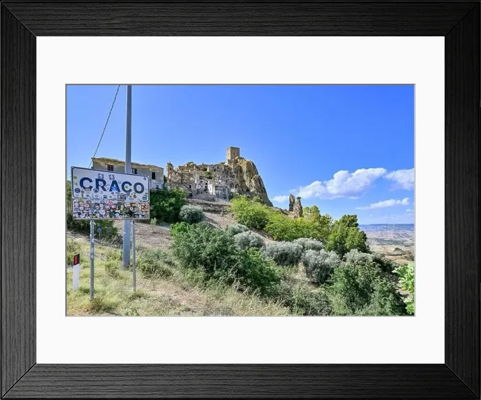Framed Print : Craco, Italy - Aug 6, 2023: Sign at the entrance of the abandoned village of Craco, Basilicata region, Italy Framed Print : Craco, Italy - Aug 6, 2023: Sign at the entrance of the abandoned village of Craco, Basilicata region, Italy
