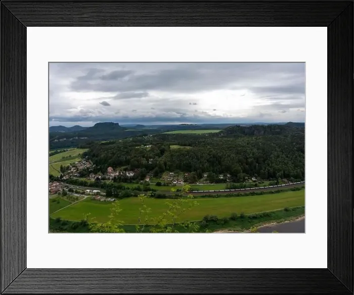 Framed Print : A train is traveling through a lush green countryside Framed Print : A train is traveling through a lush green countryside