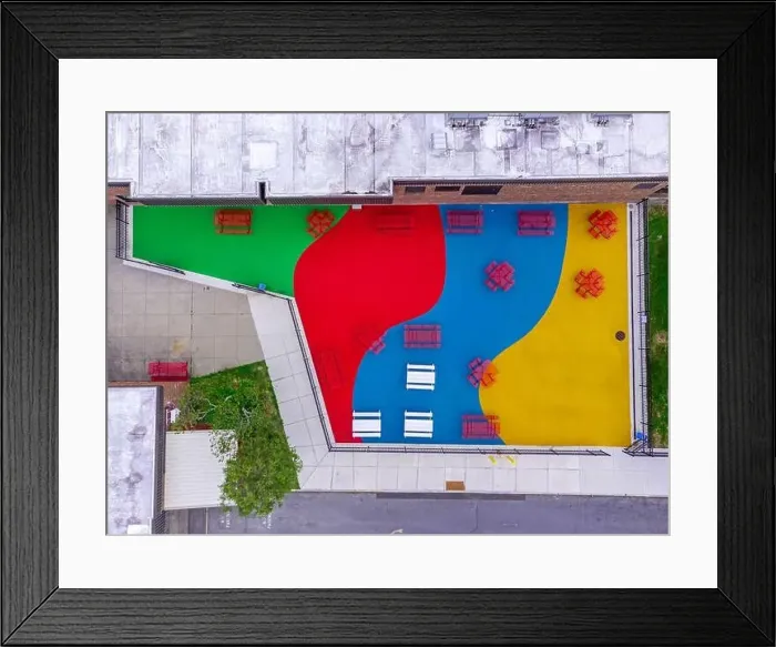 Framed Print : Aerial, drone, photo, of a red vinyl coated picnic tables on a multi color playground surface Framed Print : Aerial, drone, photo, of a red vinyl coated picnic tables on a multi color playground surface