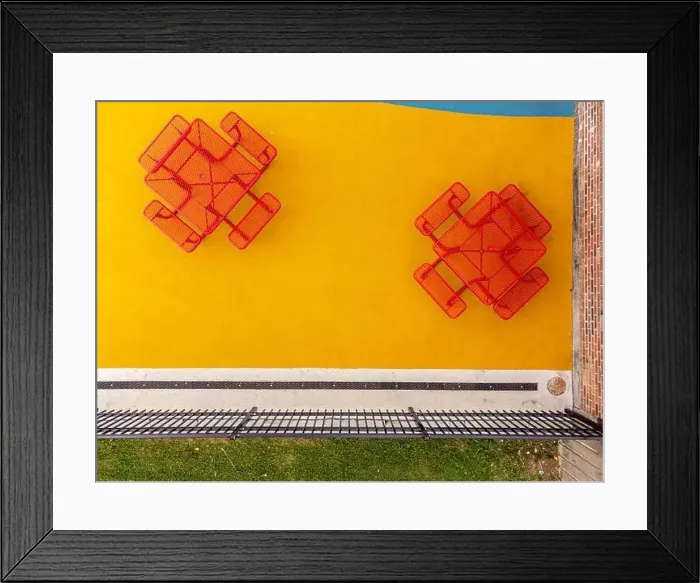 Framed Print : Aerial, drone, photo, of a red vinyl coated picnic tables on a multi color playground surface Framed Print : Aerial, drone, photo, of a red vinyl coated picnic tables on a multi color playground surface