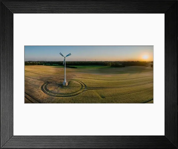 Framed Print : Aerial view of a small wind turbine gracefully spins above a gentle wheat field in atmosphere of a g Framed Print : Aerial view of a small wind turbine gracefully spins above a gentle wheat field in atmosphere of a g