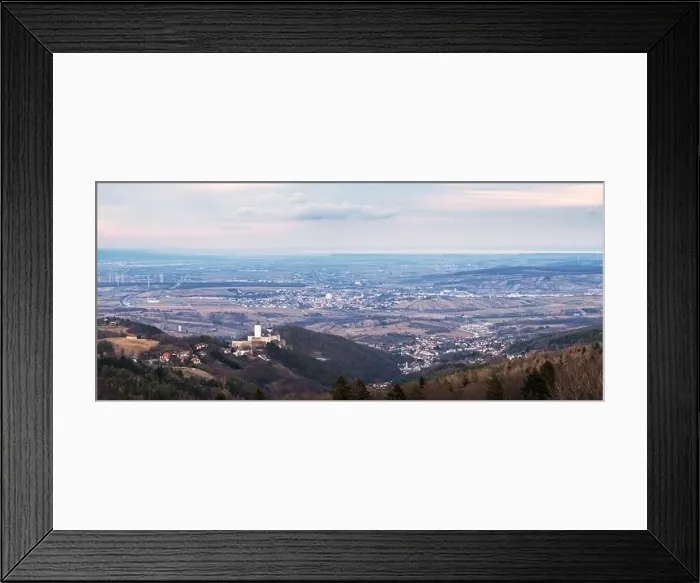 Framed Print : The medieval Forchtenstein Castle on the hilltop surrounded by dense forest below and view up to lake neusiedlersee