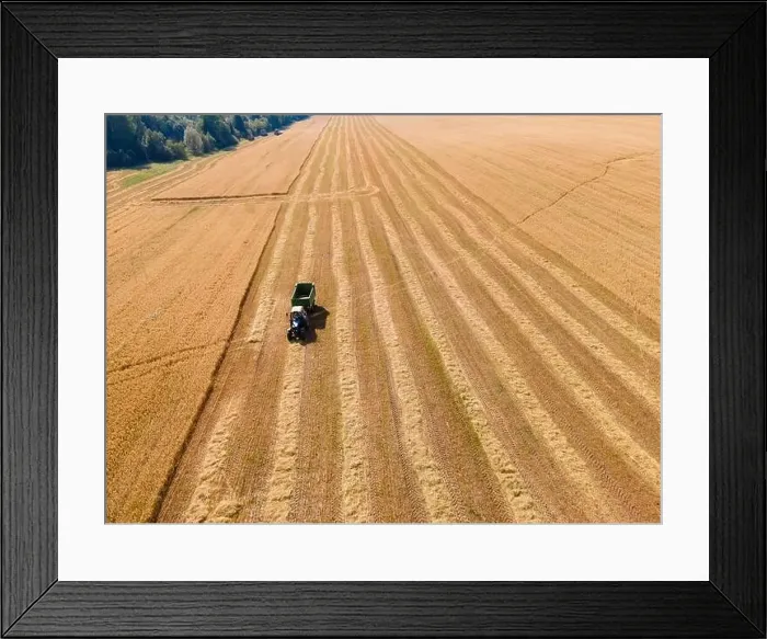 Framed Print : Agricultural field with tractor in field Framed Print : Agricultural field with tractor in field