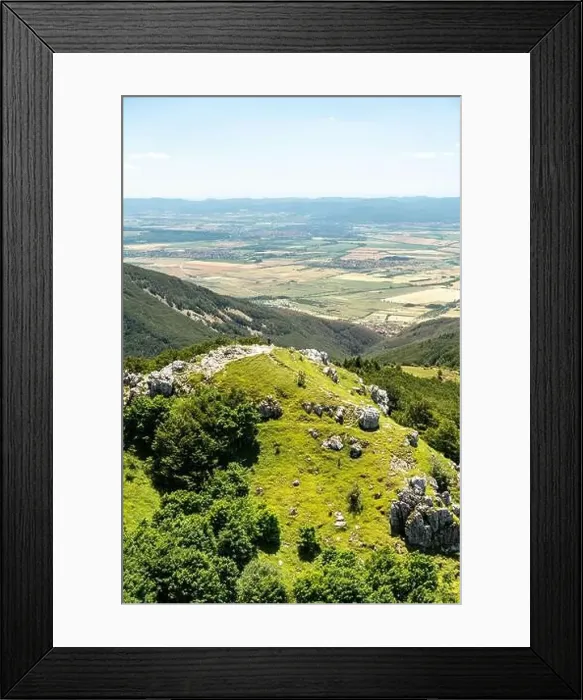 Framed Print : Hiker is enjoying a scenic view of a valley from a mountain path Framed Print : Hiker is enjoying a scenic view of a valley from a mountain path
