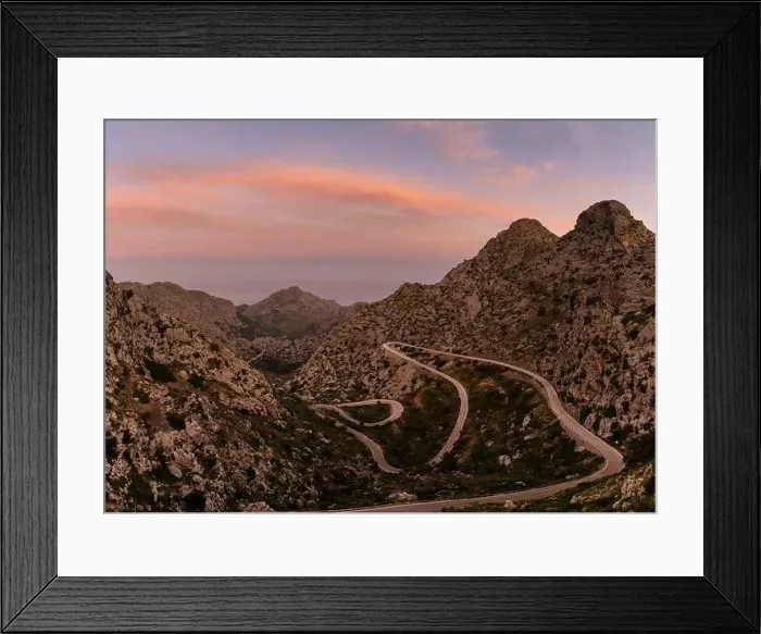 Framed Print : Sunrise in the Tramuntana mountains of Mallorca with a view of the landmark snake road leading down to Sa Calobra Framed Print : Sunrise in the Tramuntana mountains of Mallorca with a view of the landmark snake road leading down to Sa Calobra