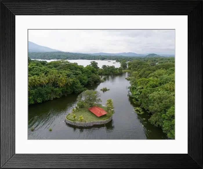 Framed Print : Small island with patio and red roof aerial drone view Framed Print : Small island with patio and red roof aerial drone view