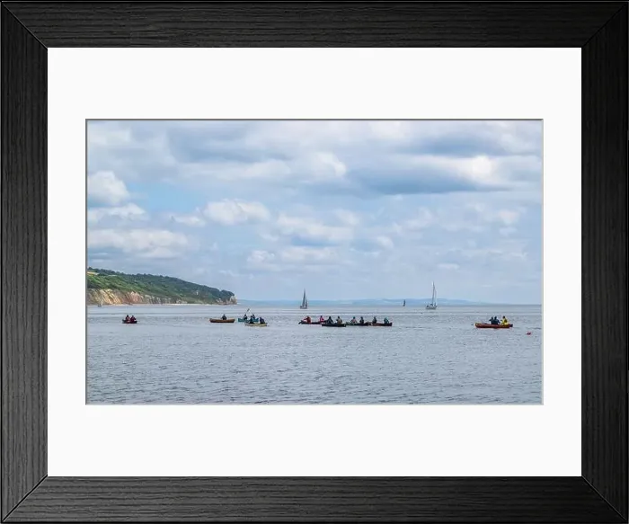 Framed Print : People in a canoe on Seaton Bay with the Haven Cliffs Naturist Beach in the background Framed Print : People in a canoe on Seaton Bay with the Haven Cliffs Naturist Beach in the background