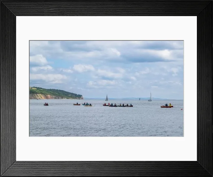 Framed Print : People in a canoe on Seaton Bay with the Haven Cliffs Naturist Beach in the background Framed Print : People in a canoe on Seaton Bay with the Haven Cliffs Naturist Beach in the background