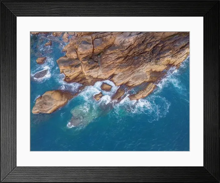 Framed Print : Aerial drone top view of beautiful waves crashing on the rocky island coast Framed Print : Aerial drone top view of beautiful waves crashing on the rocky island coast