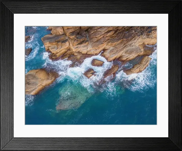 Framed Print : Aerial drone top view of beautiful waves crashing on the rocky island coast Framed Print : Aerial drone top view of beautiful waves crashing on the rocky island coast