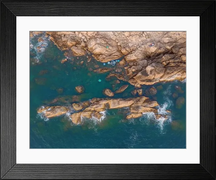 Framed Print : Aerial drone top view of beautiful waves crashing on the rocky island coast Framed Print : Aerial drone top view of beautiful waves crashing on the rocky island coast