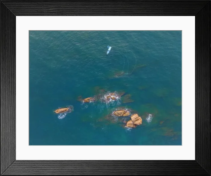 Framed Print : Aerial drone top view of beautiful waves crashing on the rocky island coast Framed Print : Aerial drone top view of beautiful waves crashing on the rocky island coast