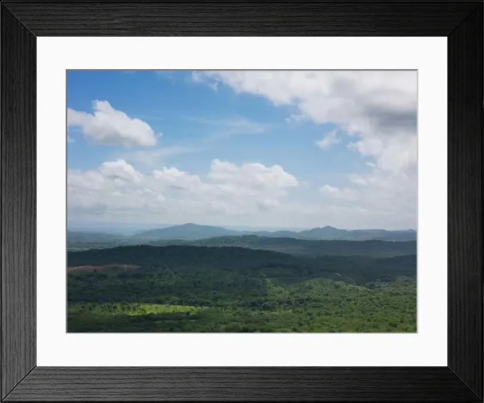 Framed Print : Green hill valley on blue sky with white clouds aerial drone view Framed Print : Green hill valley on blue sky with white clouds aerial drone view