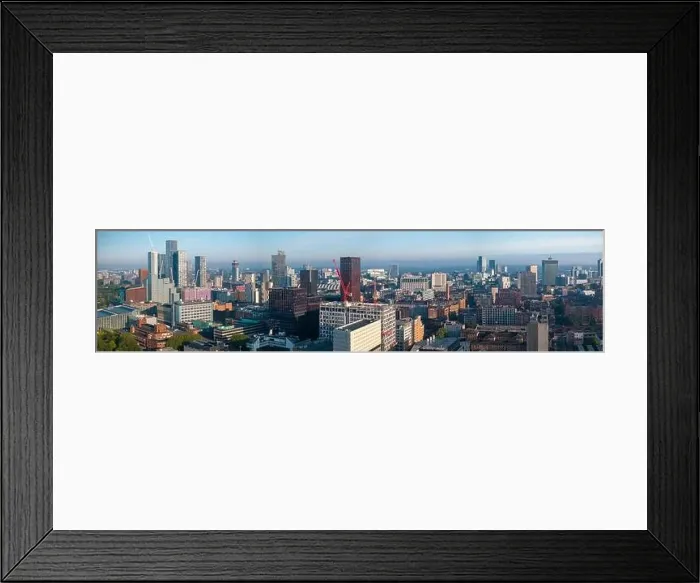 Framed Print : Aerial view of Manchester cityscape with skyscrapers and construction sites Framed Print : Aerial view of Manchester cityscape with skyscrapers and construction sites