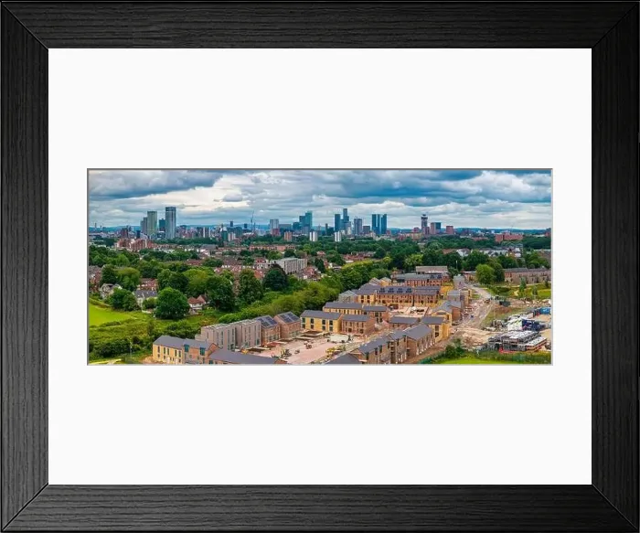 Framed Print : Aerial view of Manchester cityscape with skyscrapers and construction sites Framed Print : Aerial view of Manchester cityscape with skyscrapers and construction sites