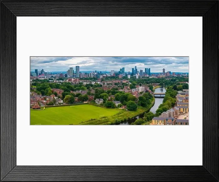 Framed Print : Aerial view of Manchester cityscape with skyscrapers and construction sites Framed Print : Aerial view of Manchester cityscape with skyscrapers and construction sites