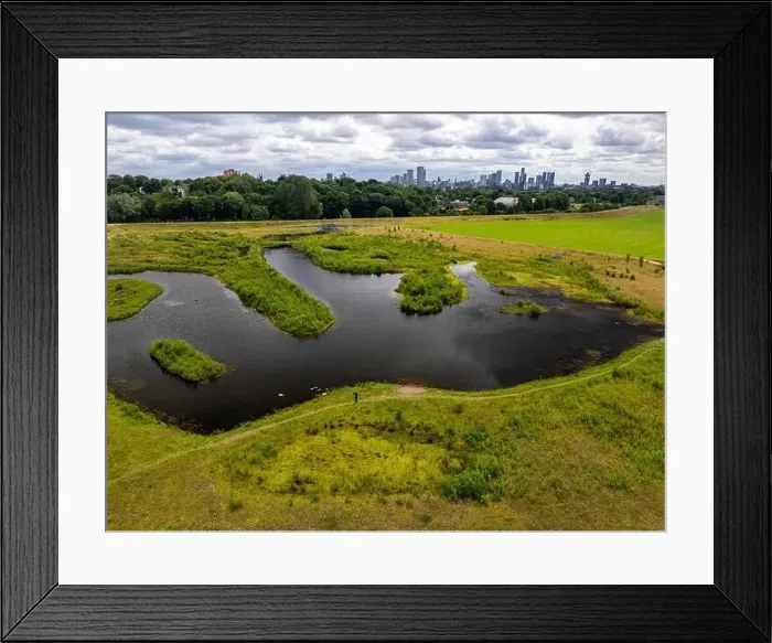 Framed Print : Aerial view of a newly created Kersal wetland park with Manchester city skyline in the background Framed Print : Aerial view of a newly created Kersal wetland park with Manchester city skyline in the background