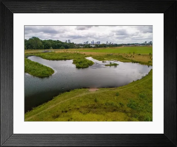 Framed Print : Aerial view of a newly created Kersal wetland park with Manchester city skyline in the background Framed Print : Aerial view of a newly created Kersal wetland park with Manchester city skyline in the background