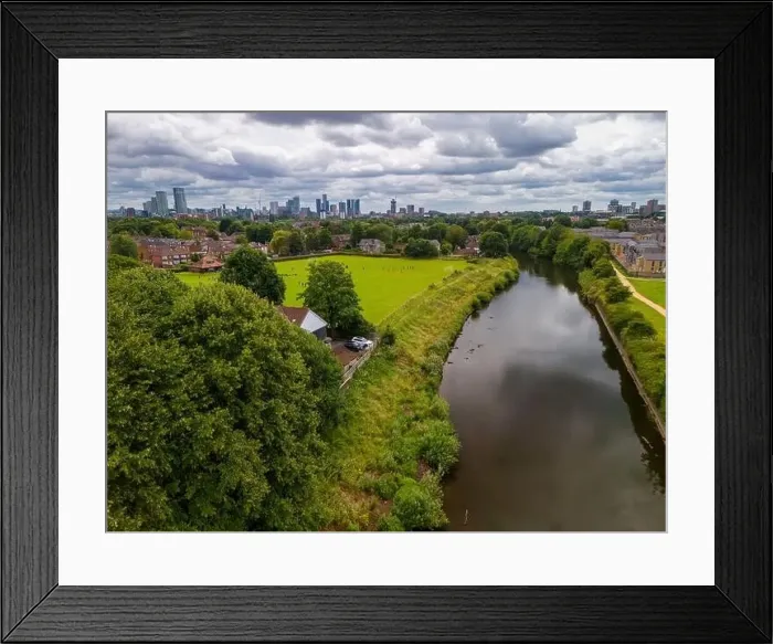 Framed Print : Aerial view of a park in Salford with a river Irwell, buildings, and a city of Manchester skyline in the background Framed Print : Aerial view of a park in Salford with a river Irwell, buildings, and a city of Manchester skyline in the background