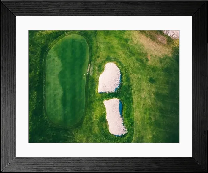 Framed Print : The green of a golf course is prominently displayed from above