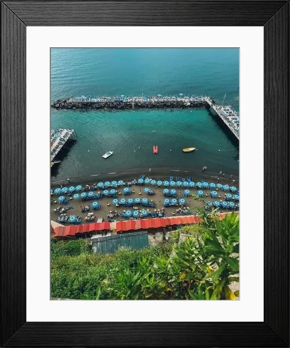 Framed Print : A beach with many umbrellas and boats. The beach is crowded with people and the water is calm Framed Print : A beach with many umbrellas and boats. The beach is crowded with people and the water is calm
