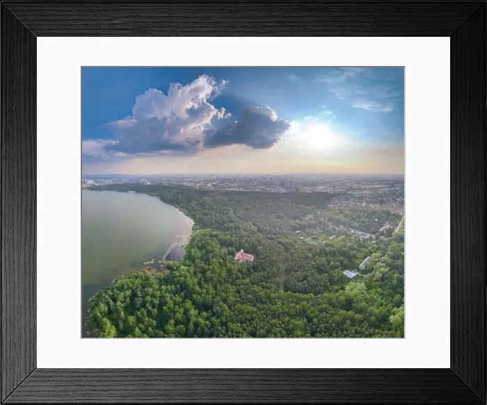 Framed Print : Big lake with green shores in bright sun light and city on horizon Framed Print : Big lake with green shores in bright sun light and city on horizon