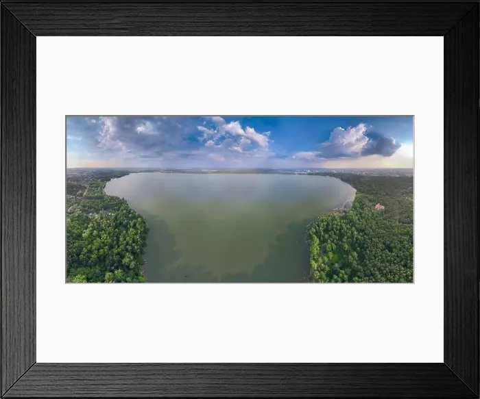 Framed Print : Big lake with green shores in bright sun light and city on horizon Framed Print : Big lake with green shores in bright sun light and city on horizon