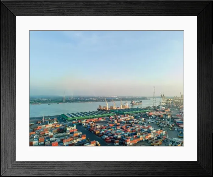 Framed Print : Aerial View of Busy Container Port and Cargo Ships on River - Industrial Shipping and Global Trade Scene Framed Print : Aerial View of Busy Container Port and Cargo Ships on River - Industrial Shipping and Global Trade Scene