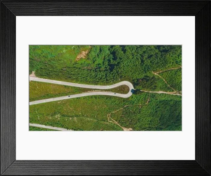 Framed Print : Aerial shot captures the verdant landscape of Azores with winding roads curving through lush greenery Framed Print : Aerial shot captures the verdant landscape of Azores with winding roads curving through lush greenery