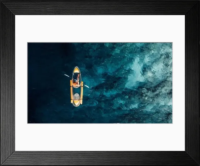 Framed Print : Woman kayaking in blue ocean on transparent kayak. Drone view with copy space Framed Print : Woman kayaking in blue ocean on transparent kayak. Drone view with copy space