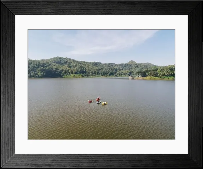 Framed Print : Aerial drone view of people riding kayak boat, paddling in the Sermo lake, Yogyakarta, Indonesia Framed Print : Aerial drone view of people riding kayak boat, paddling in the Sermo lake, Yogyakarta, Indonesia