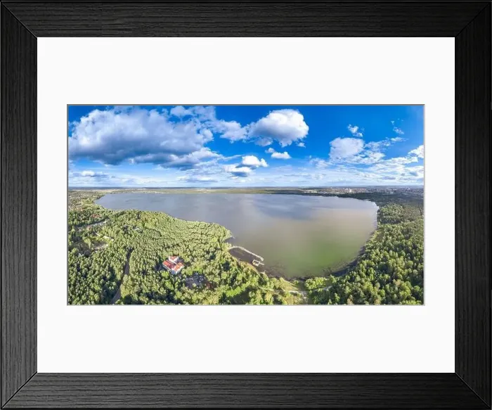 Framed Print : Big lake with green shores in bright sun light and city on horizon Framed Print : Big lake with green shores in bright sun light and city on horizon