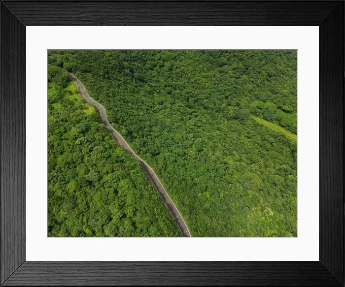 Framed Print : Mountain road on green hill jungle background on sunny day aerial drone view Framed Print : Mountain road on green hill jungle background on sunny day aerial drone view