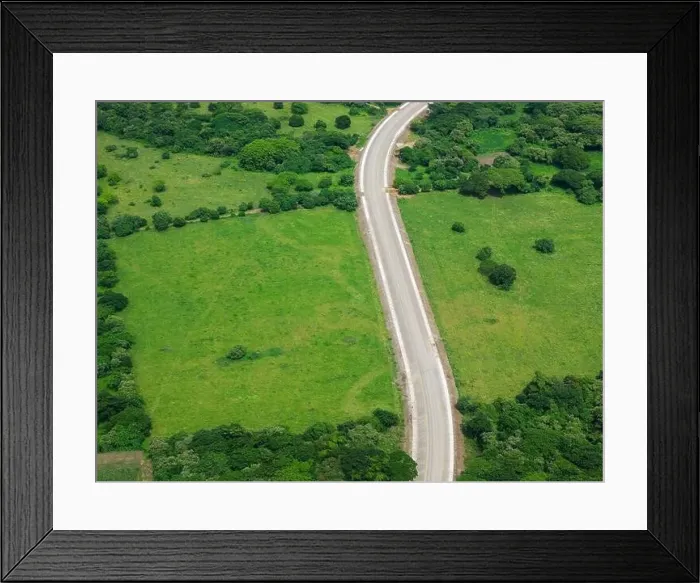 Framed Print : Road in green natural field landscape aerial drone view Framed Print : Road in green natural field landscape aerial drone view