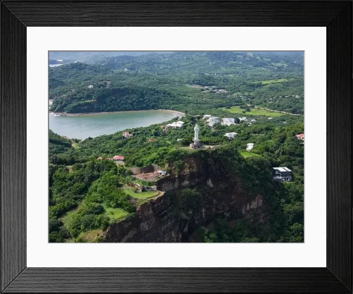 Framed Print : Jesus statue on rock cliff in green hill landscape aerial drone view Framed Print : Jesus statue on rock cliff in green hill landscape aerial drone view