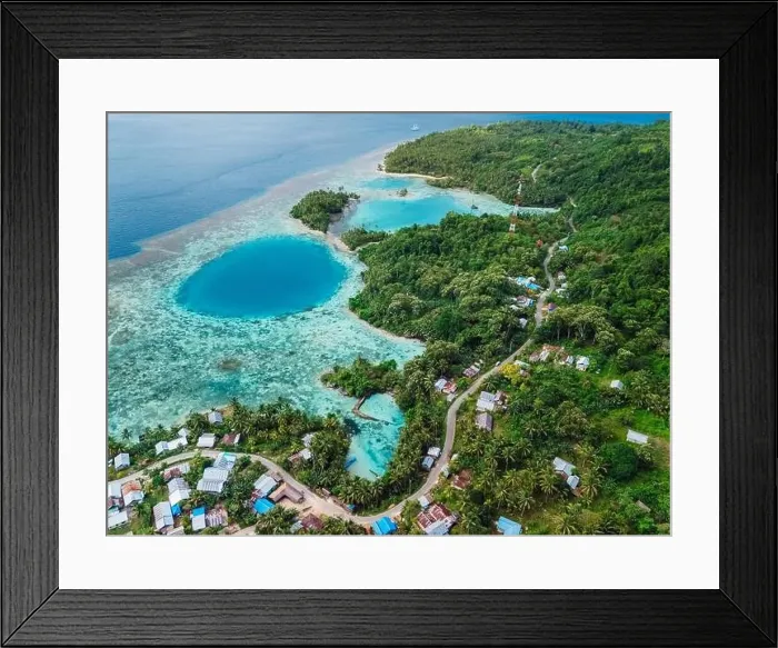 Framed Print : Sea coastline with blue hole in big lagoon and village, scenic landscape in Indonesia. Aerial view Framed Print : Sea coastline with blue hole in big lagoon and village, scenic landscape in Indonesia. Aerial view