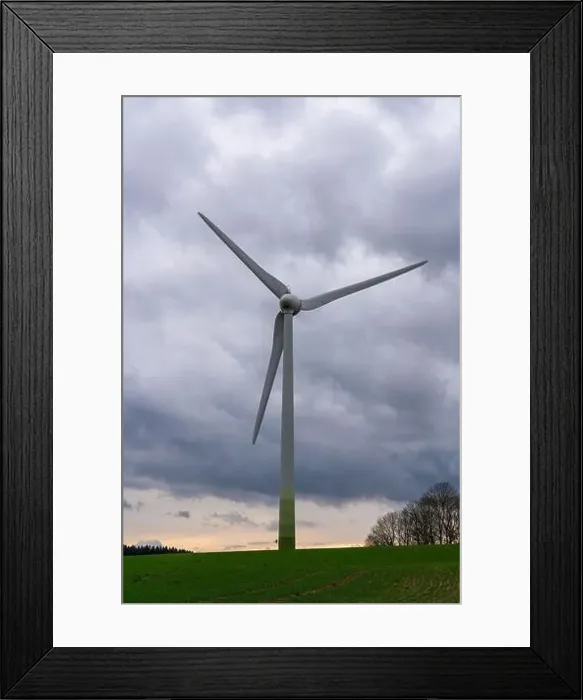 Framed Print : Windmill against a gray sky stands in field. Rural landscape. Wind turbine. Sources of energy Framed Print : Windmill against a gray sky stands in field. Rural landscape. Wind turbine. Sources of energy