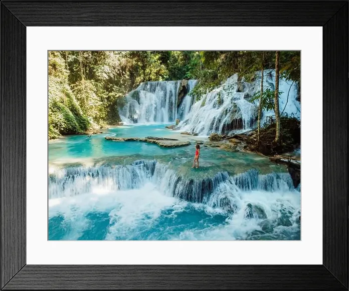 Framed Print : Scenic cascade waterfall with clear blue water and alone beauty woman in Central Sulawesi, drone view Framed Print : Scenic cascade waterfall with clear blue water and alone beauty woman in Central Sulawesi, drone view