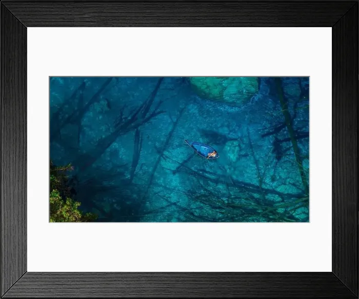 Framed Print : Woman on boat floating in most transparent lake with crystal blue fresh water in Sulawesi, Indonesia. Aerial view Framed Print : Woman on boat floating in most transparent lake with crystal blue fresh water in Sulawesi, Indonesia. Aerial view