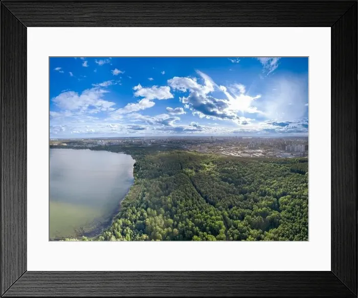 Framed Print : Big lake with green shores in bright sun light and city on horizon Framed Print : Big lake with green shores in bright sun light and city on horizon