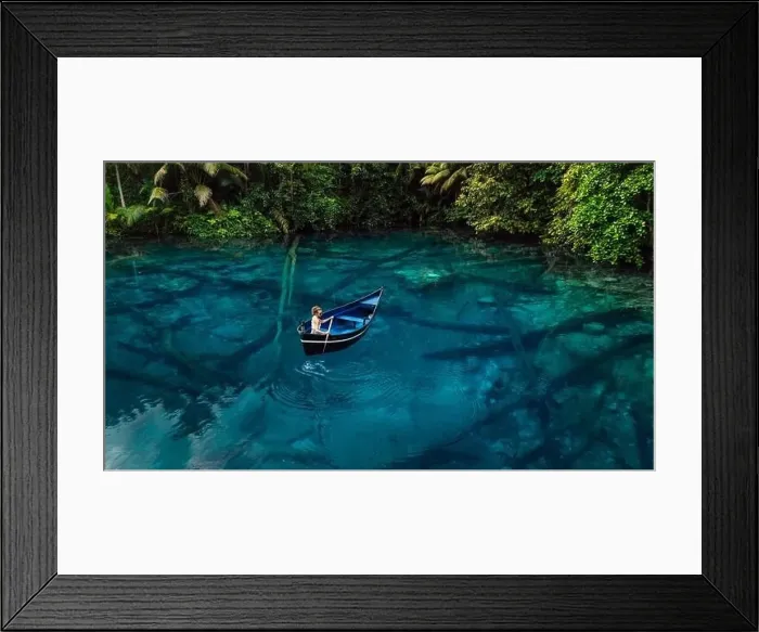 Framed Print : Woman on boat in tropical transparent lake with crystal blue water in Sulawesi, Indonesia. Aerial view