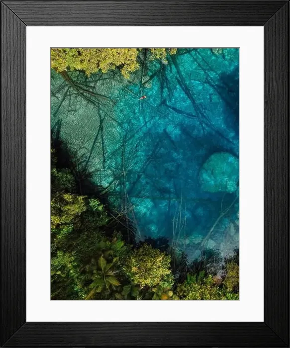 Framed Print : Woman swims in tropical transparent lake with crystal water in Sulawesi, Indonesia. Aerial view Framed Print : Woman swims in tropical transparent lake with crystal water in Sulawesi, Indonesia. Aerial view