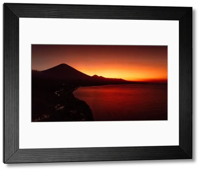 Framed Print : Drone view panorama of coastline with silhouette of volcano and sunset with quiet sea in Bali Framed Print : Drone view panorama of coastline with silhouette of volcano and sunset with quiet sea in Bali