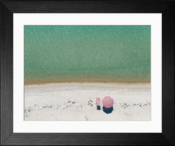 Framed Print : Aerial shot of an empty sandy beach and sea with a sun lounger and umbrella Framed Print : Aerial shot of an empty sandy beach and sea with a sun lounger and umbrella