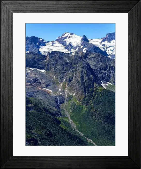 Framed Print : View of a small river with a waterfall flowing out of a mountain glacier Framed Print : View of a small river with a waterfall flowing out of a mountain glacier