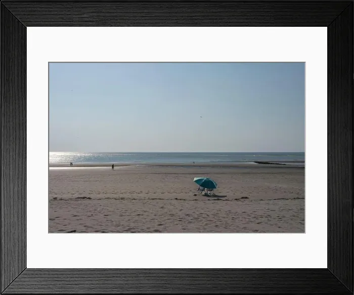 Framed Print : View a man and a woman siiting sitting under a parasol looking at the sea Framed Print : View a man and a woman siiting sitting under a parasol looking at the sea