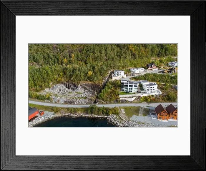 Framed Print : Aerial view of a coastal village with wooden houses along a fjord, surrounded by forested hills in autumn colors Framed Print : Aerial view of a coastal village with wooden houses along a fjord, surrounded by forested hills in autumn colors