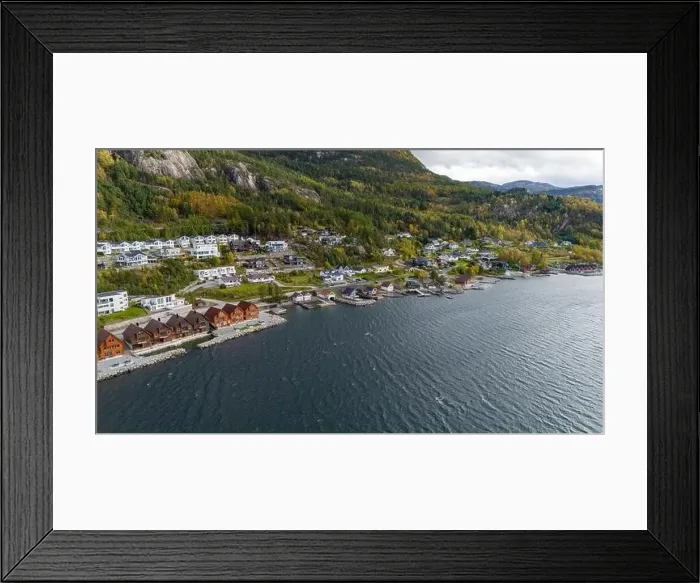 Framed Print : Aerial view of a coastal village with wooden houses along a fjord, surrounded by forested hills in autumn colors Framed Print : Aerial view of a coastal village with wooden houses along a fjord, surrounded by forested hills in autumn colors