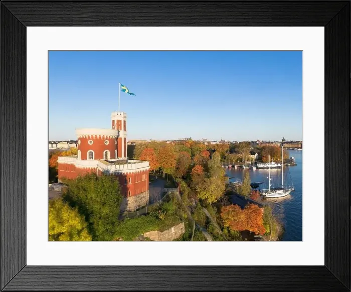 Framed Print : Kastellholmen red castle on island with Stockholm skyline in the background on a sunny autumn morning with turning Framed Print : Kastellholmen red castle on island with Stockholm skyline in the background on a sunny autumn morning with turning